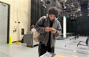 student scanning documents on phone for sos 